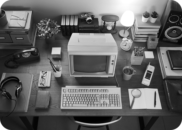 Top-down view of an organized desk with an old CRT computer.