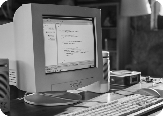 Old CRT monitor showing code editor on screen